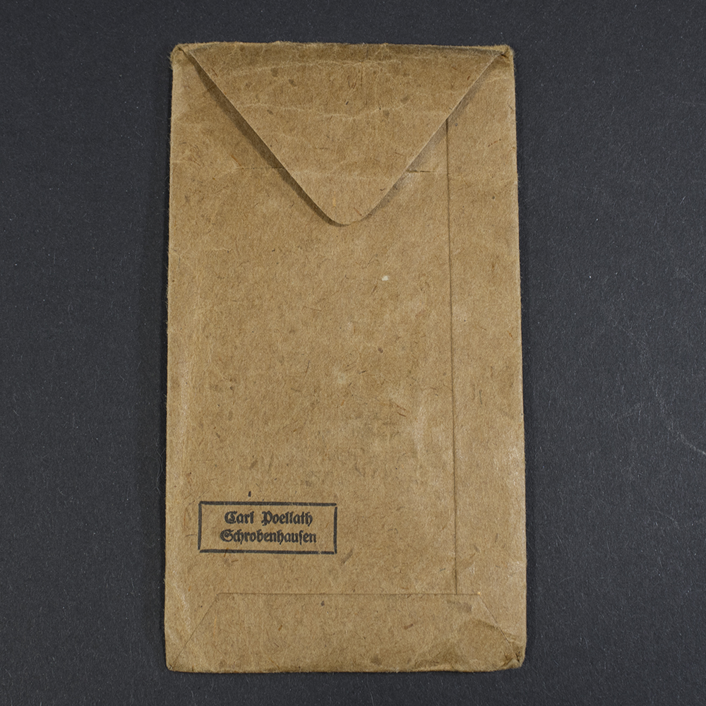Rear view of the brown medal bag, showing the plain untreated paper surface and fold lines.