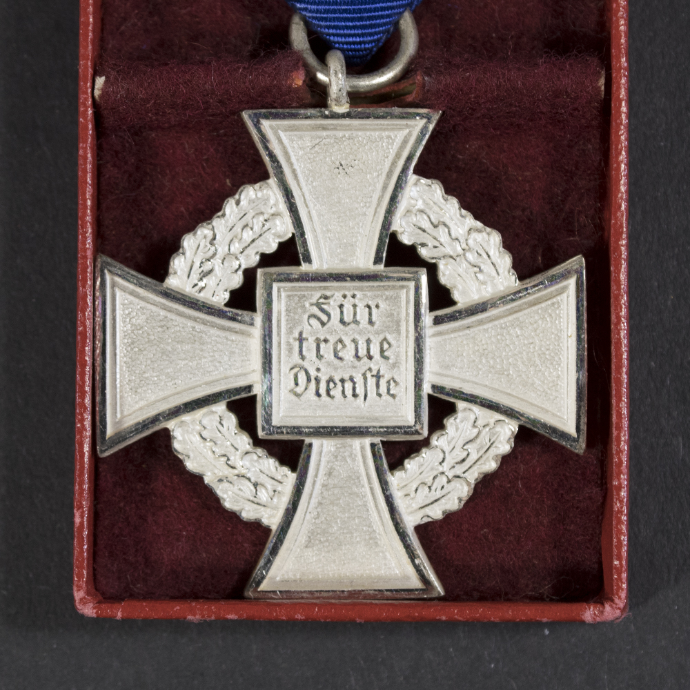 Close-up of the back of a WWII German Faithful Service Medal, showing the plain reverse surface and edge details.