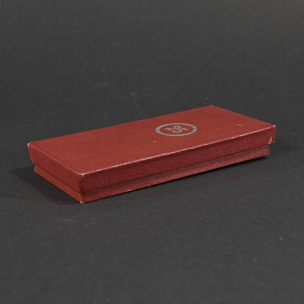 Angled view of the closed original case for a WWII German Faithful Service Medal, showing the textured exterior and hinge.”