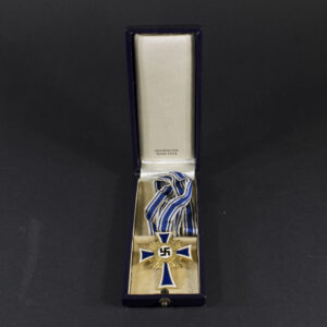 WW2-era German Mother’s Cross in gold displayed inside its original presentation case, shown open.