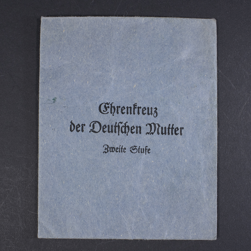Overview of the original cloth bag for a WWII German Mother’s Cross, showing both the front and back sides laid flat.