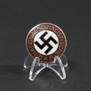 Overview of a WWII German NSDAP membership pin, showing the circular enamel badge with its metal backing.