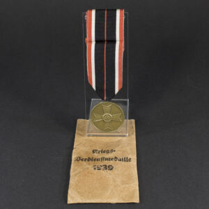 WW2-era German War Merit Medal set with original paper bag, shown together.