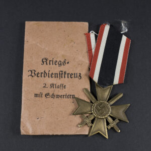 WW2-era German War Merit Cross with Swords set displayed with its original paper issue bag.