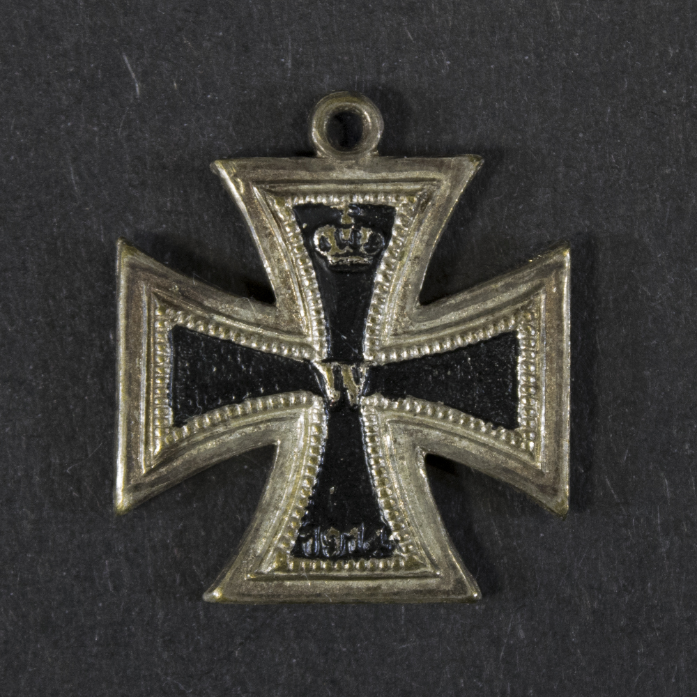 Front view of a German WW1 Iron Cross 2nd Class miniature (16 mm), showing the cross design and central core.