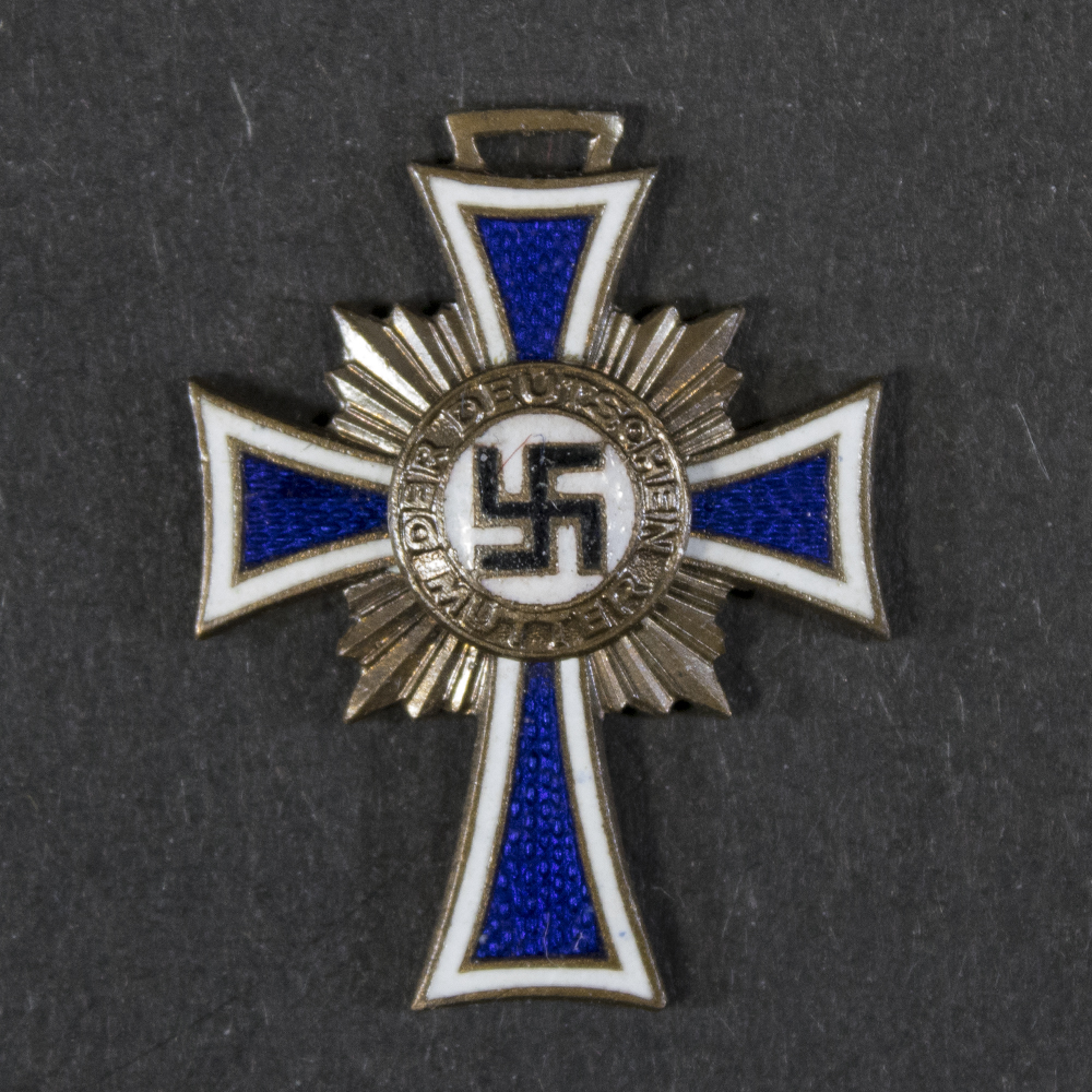 Front view of a WW2-era German Bronze Mother’s Cross miniature, showing the cross design and enamel details.