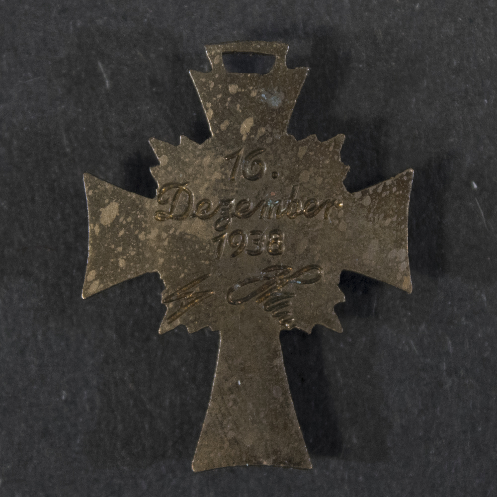 Back view of the German Bronze Mother’s Cross miniature, showing the reverse surface and suspension ring.