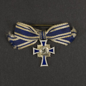 Overview of a WWII German Gold Mother’s Cross miniature, showing the complete miniature medal with ribbon.