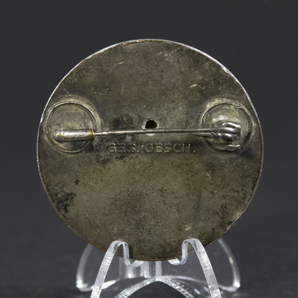 Close‑up of the reverse of a WWII German DRK Schwesterhelferin brooch, showing the pin assembly and metal finish.