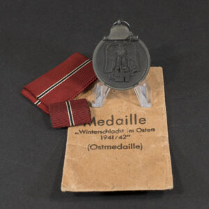 Overview of a WWII German Eastern Front Medal displayed together with its original issue bag.