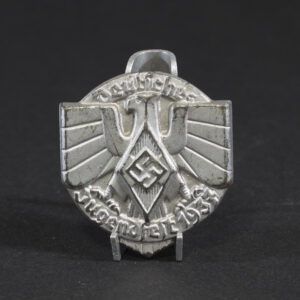 Overview of a WWII German tinnie from a Hitler Youth sports event held in 1937, showing the complete badge.