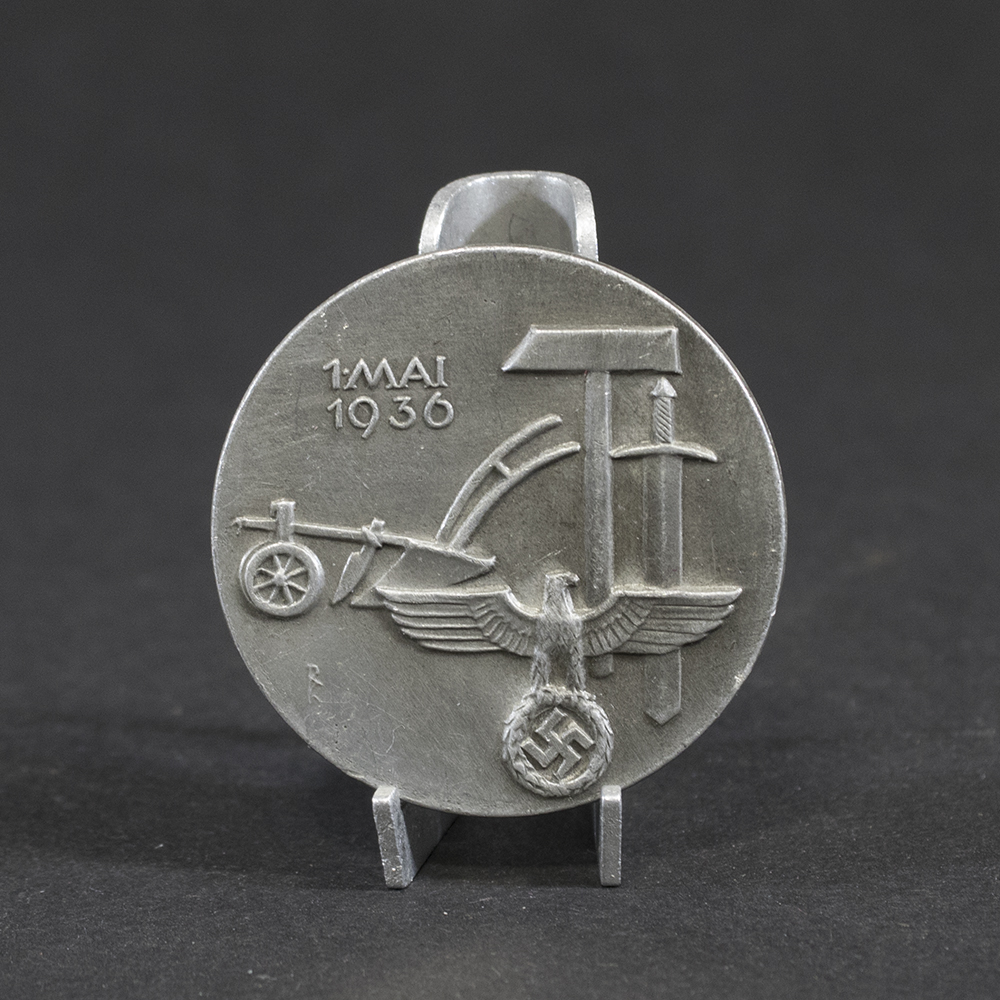 Overview of a WWII German “Tag der Arbeit” 1936 tinnie, showing the complete event badge.