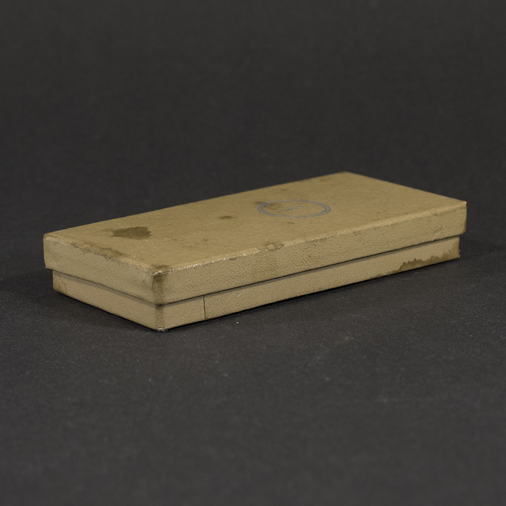 Angled view of the closed original presentation case for a WWII German RAD 4‑year long service medal.