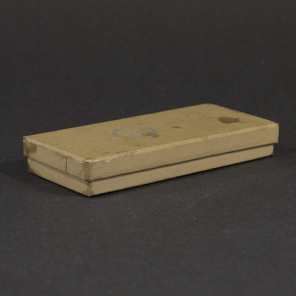 Second angled view of the closed presentation case for a WWII German RAD 4‑year long service medal, showing exterior texture and shape.