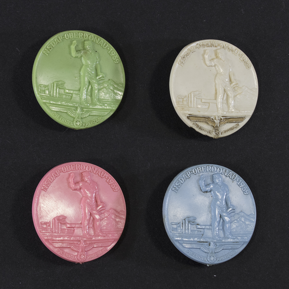 Front view of a set of 4 NSDP Oberdonau 1939 Kreistag Abzeichen badges. showing all their detail.
