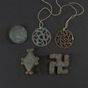 Front view of a set of 5 Winterhilfswerk badges.