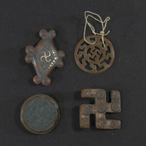 Front view of a set of 4 Winterhilfswerk badges.