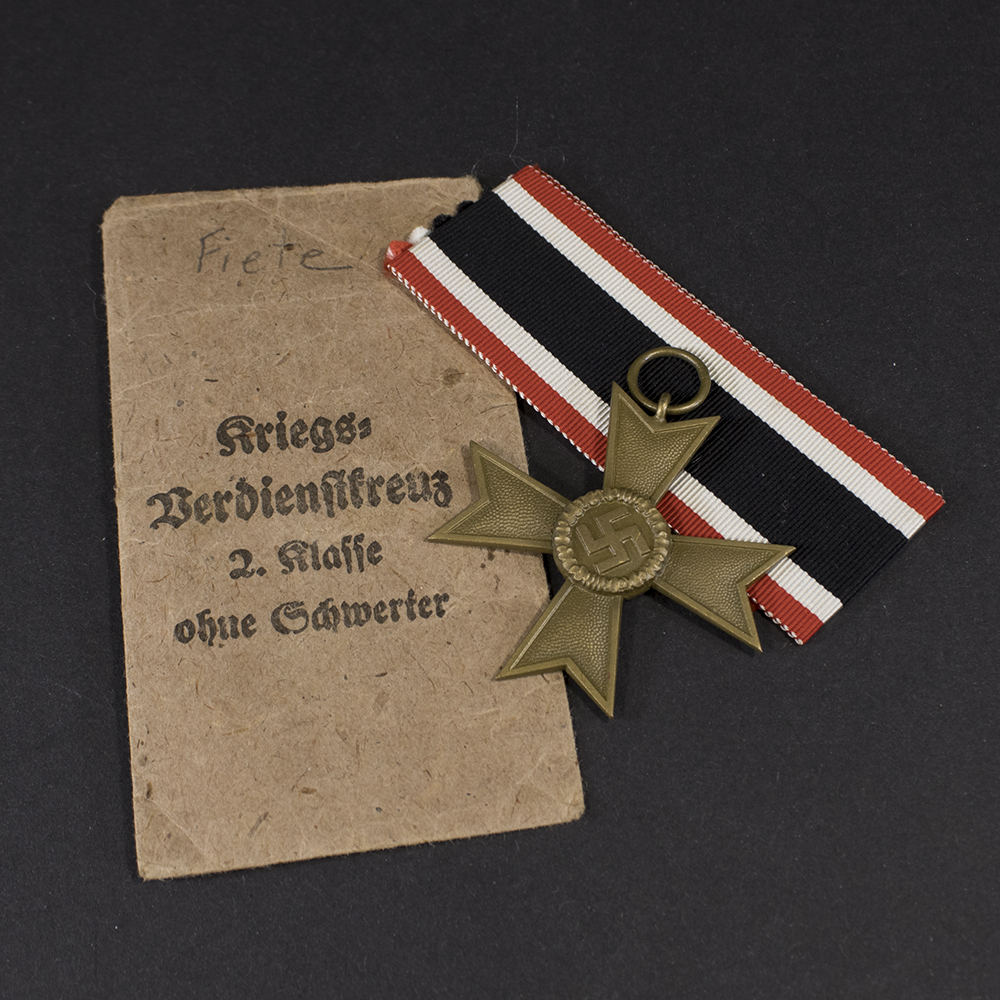 Overview of a WW2 German War Merit Cross without Swords displayed with its original presentation bag.