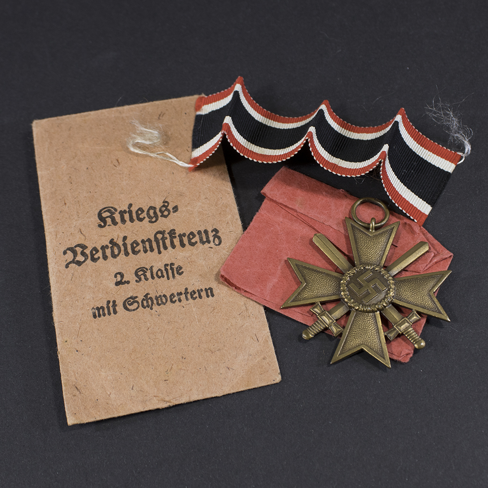 Overview of a WW2 German War Merit Cross without Swords displayed with its original presentation bag.