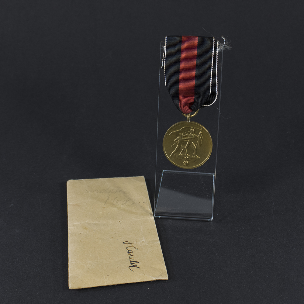Overview of a WW2 German Sudetenland Occupation Medal displayed with its original presentation bag.