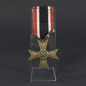 Overview of a World War II-era German War Merit Cross (without swords), shown with its original ribbon, displaying the bronze cross suspended from a striped ribbon against a neutral background.