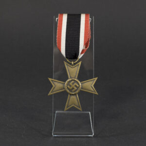 Overview of a World War II-era German War Merit Cross (without swords), shown with its original ribbon, displaying the bronze cross suspended from a striped ribbon against a neutral background.