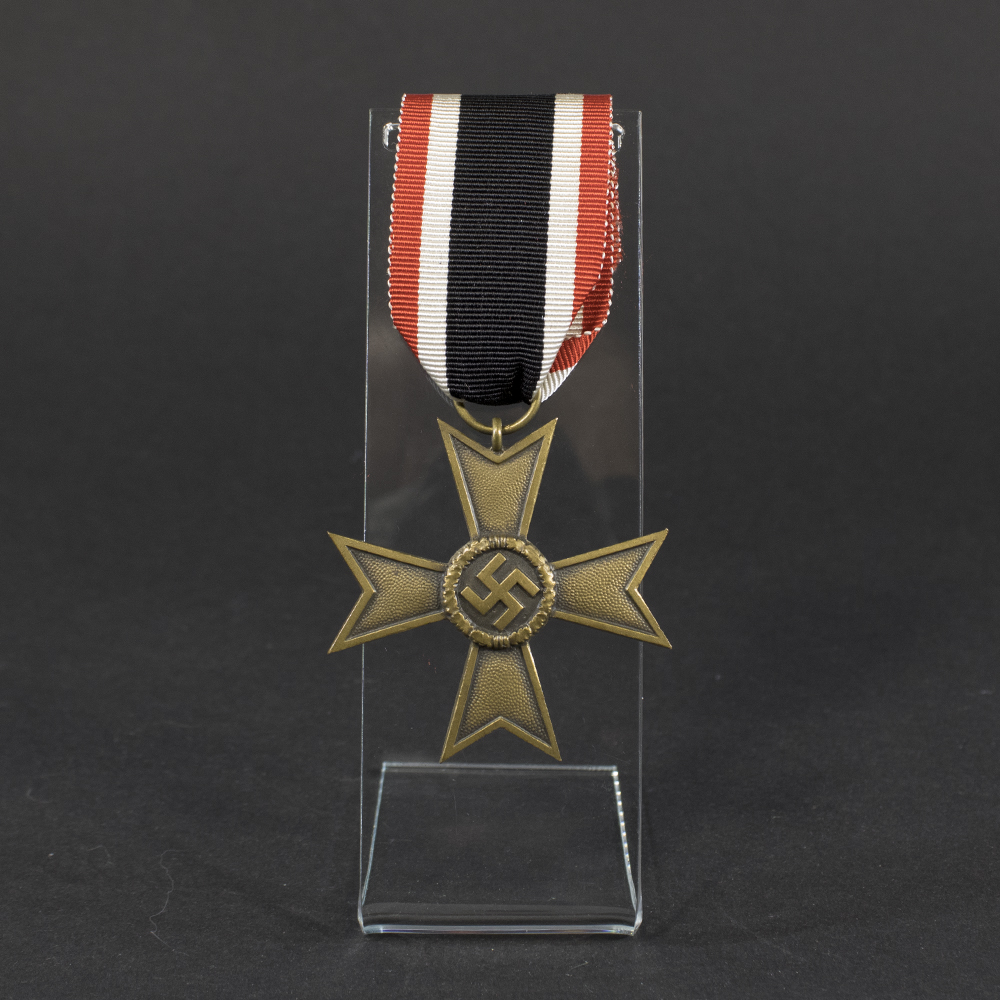 Overview of a World War II-era German War Merit Cross (without swords), shown with its original ribbon, displaying the bronze cross suspended from a striped ribbon against a neutral background.