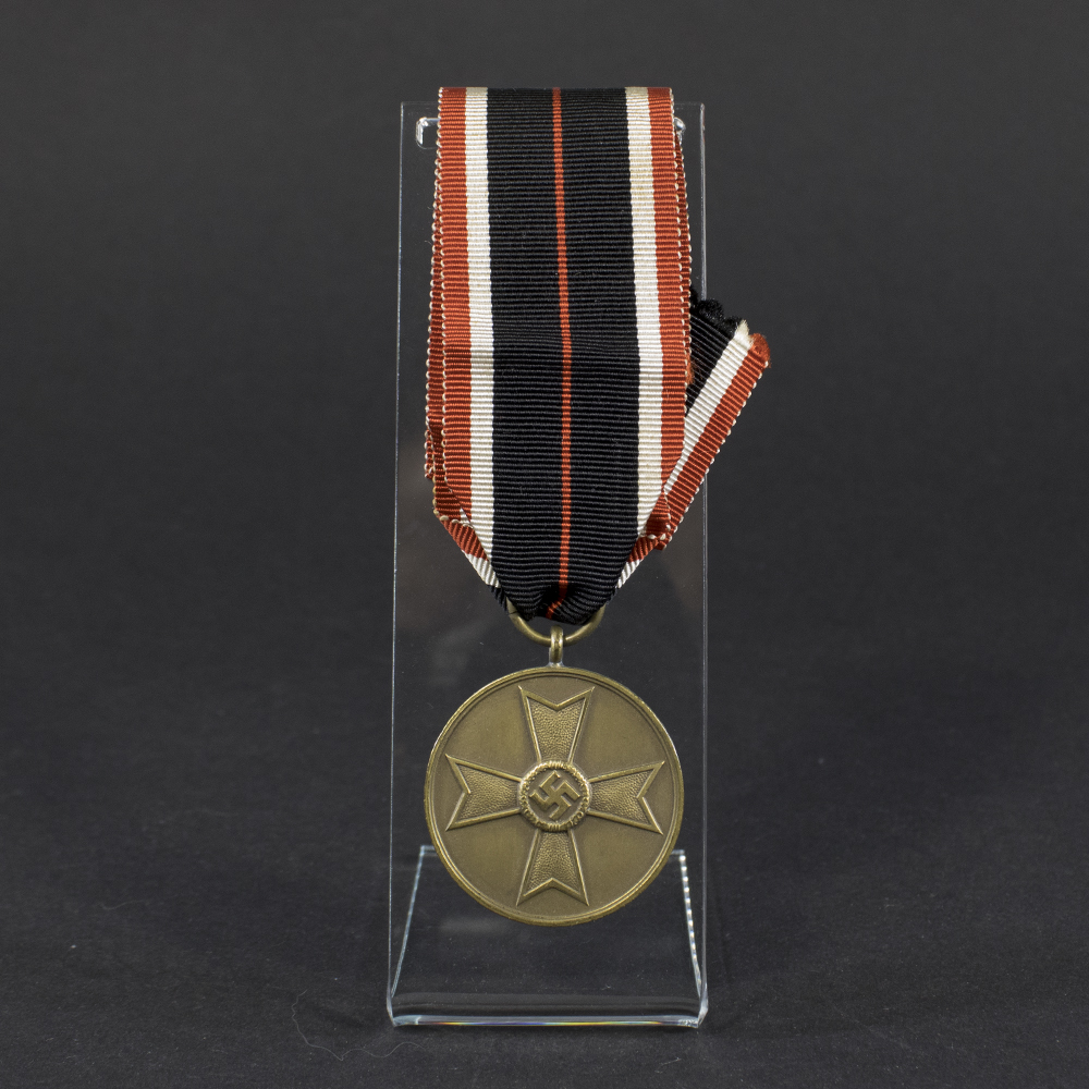 Overview of a World War II-era German War Merit Medal, shown with its ribbon, displaying the round bronze medal suspended from a striped ribbon against a neutral background.