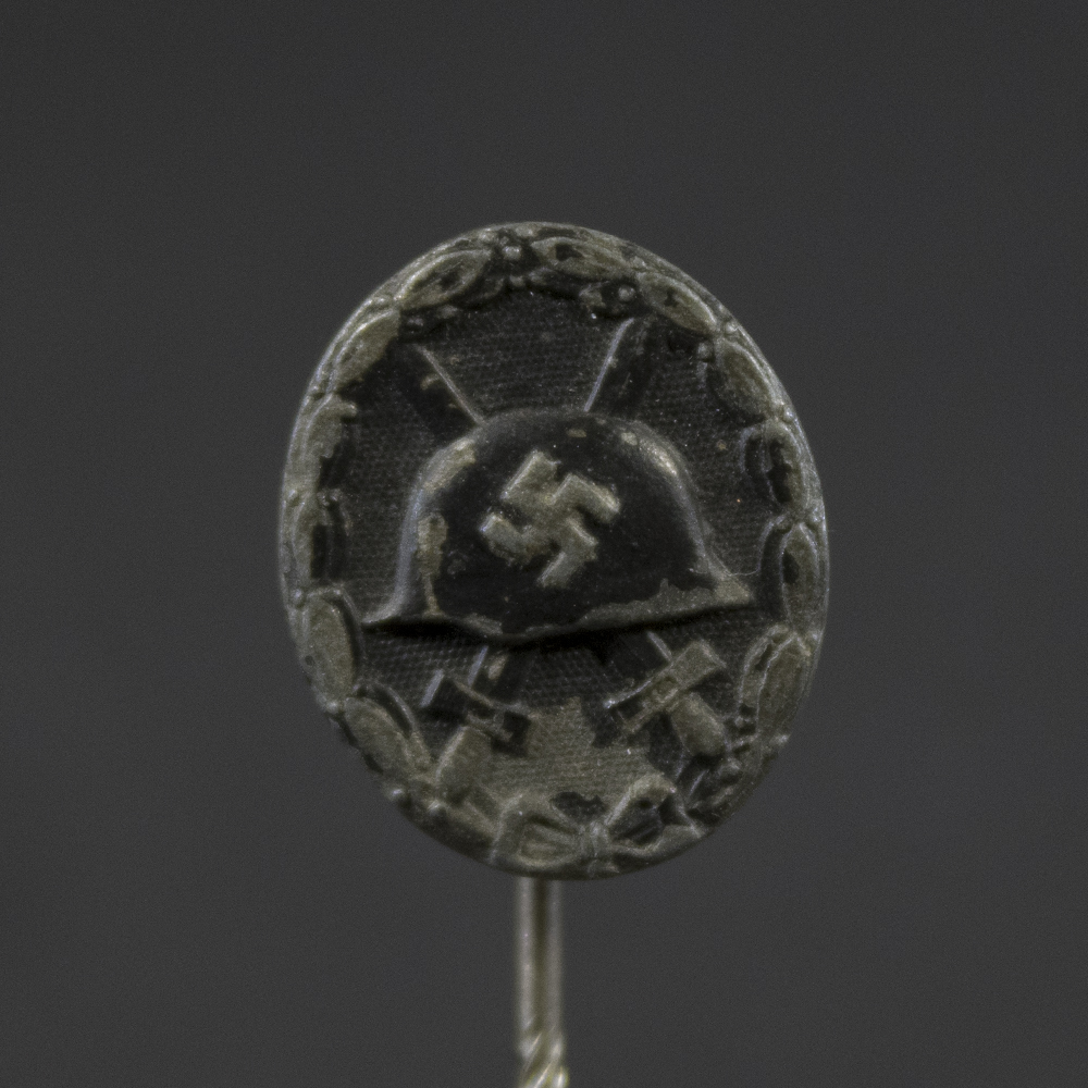 Close-up front view of German WW2 Black Wound Badge stickpin showing design and finish