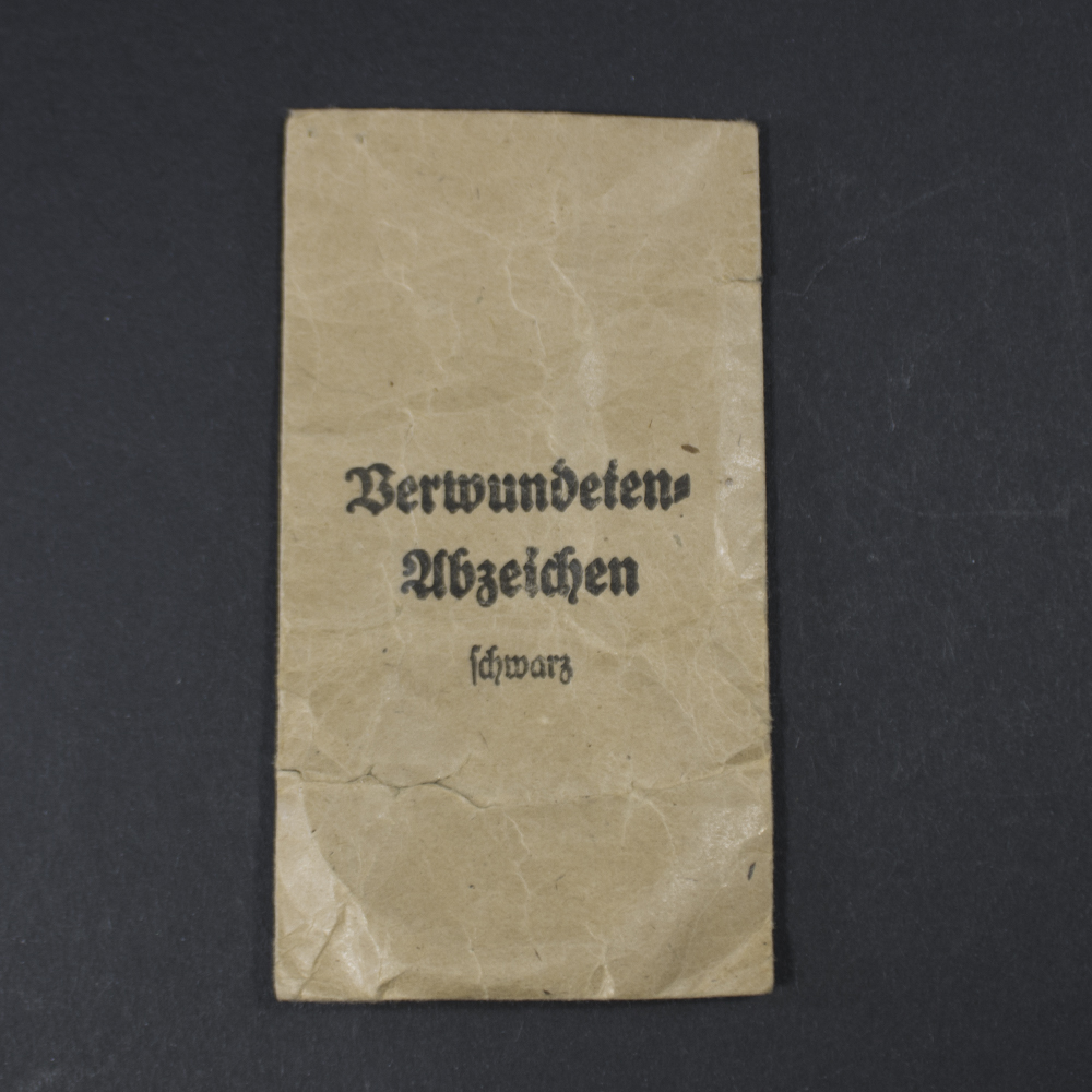 Front view of original bag for WW2 Black Wound Badge showing paper texture