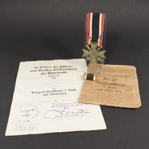 WW2 German War Merit Cross with Swords set including medal, ribbon, paper bag, and award document overview
