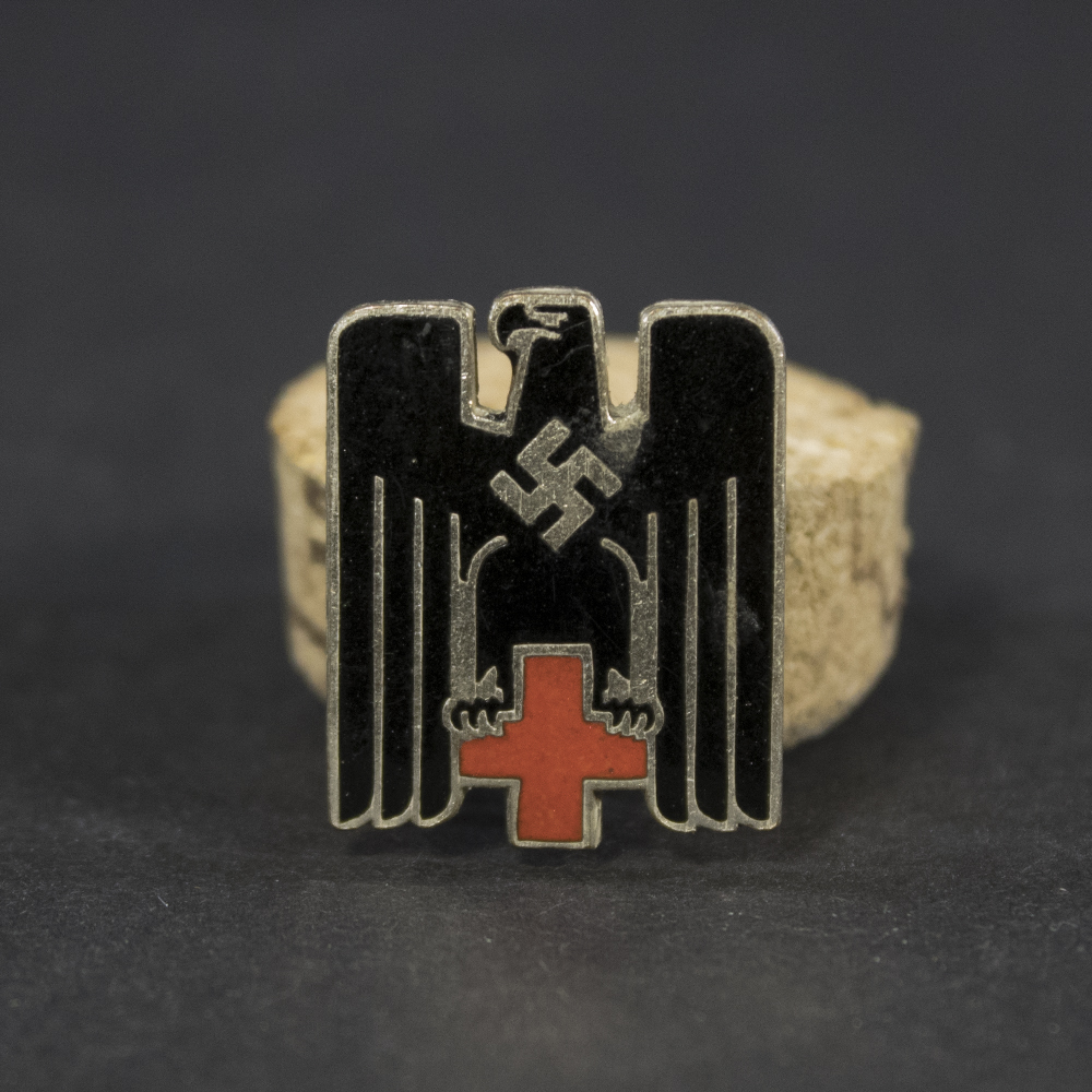 Overview of a German Red Cross (DRK) cap badge from the Nazi era, showing the complete insignia and its overall condition.