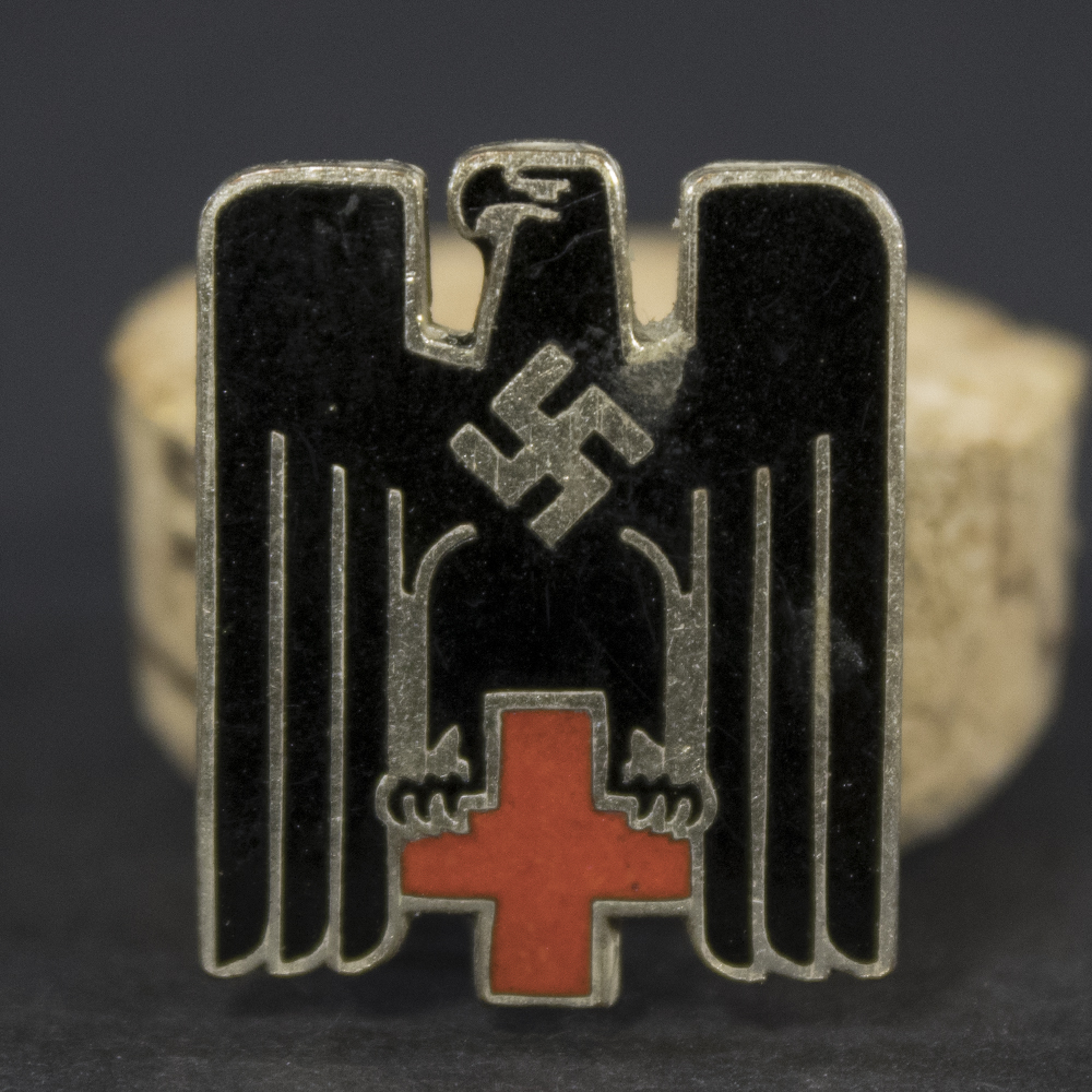 Detailed front view of the Nazi-era German Red Cross cap badge, highlighting the design, finish, and visible insignia details.