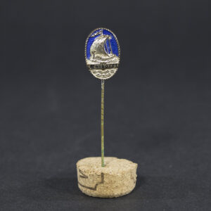 Overview of a Marinebrigade Ehrhardt membership pin, showing the badge together with its reverse needle attachment.