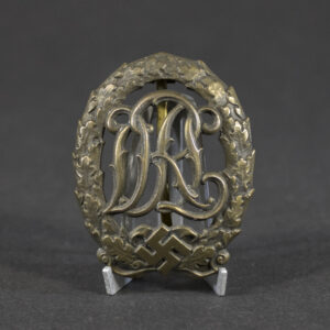 Overview of a WWII German Bronze DRL Sports Badge with original bronze finish and maker mark by Ernst Schneider.