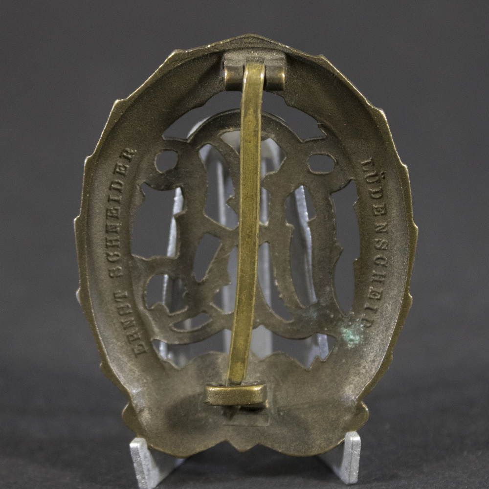 Close-up of the reverse of a WWII German Bronze DRL Sports Badge displaying the pin assembly and original construction details.