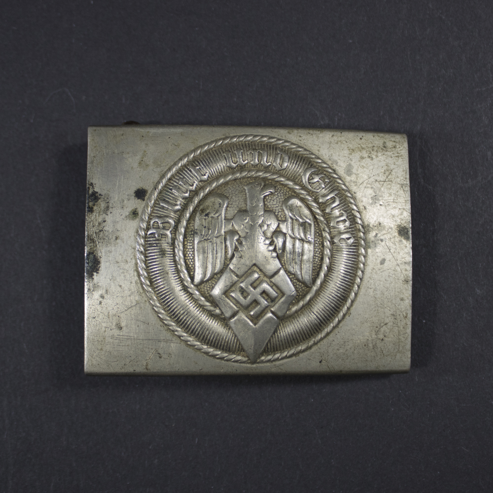 Overview of a Hitler Youth belt buckle from Nazi Germany showing the iconic HJ diamond emblem and original finish.
