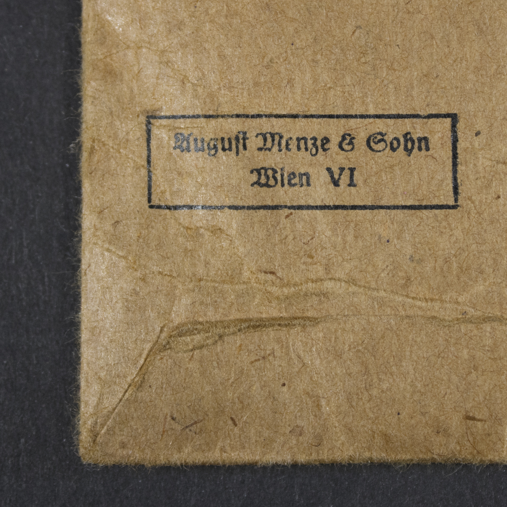Detailed close-up of the August Menze maker mark on the reverse of the original West Wall Medal issue bag.