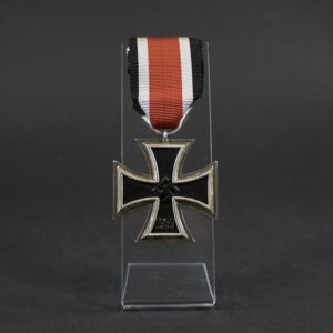 German World War II Iron Cross 2nd Class medal displayed in full view, showing the black iron core with a silver-colored frame and the attached suspension ring with ribbon.