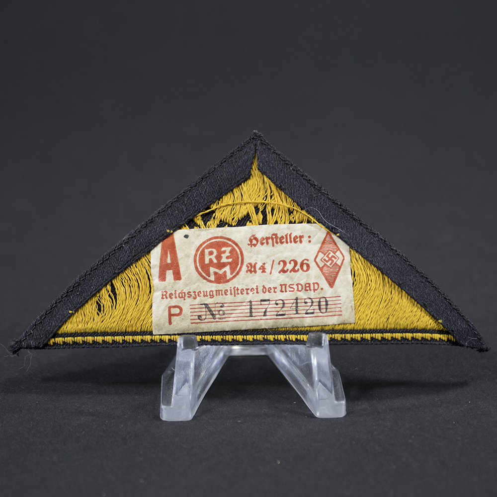 Close-up of the reverse side of the HJ Gebietsdreieck “Südost Wien” patch, showing the backing material, stitching, and attached RZM manufacturer tag with visible markings and construction details.