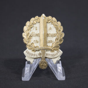 Overview of a World War II-era German tinnie commemorating SA Gruppenwettkämpfe Donau, shown in full view to display the complete design, shape, and overall condition of the badge.