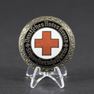 Overview of a DRK Schwesternhelferin brooch, shown in full view to display the complete design, shape, and overall condition of the nursing aide insignia.