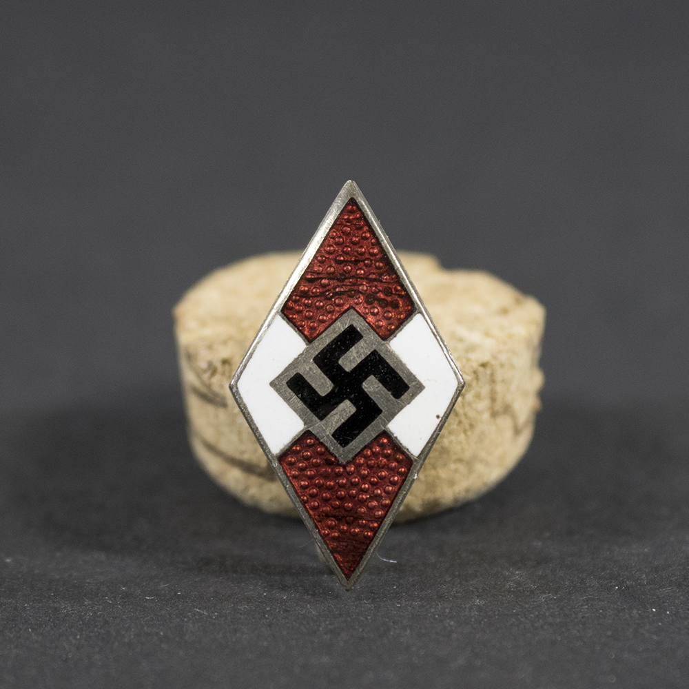 Overview of an RZM 11-marked Hitler Youth membership pin, displayed in full view to show the diamond-shaped design, enamel finish, and overall condition of the badge.