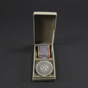 Overview of a cased World War II German Air Defence Medal 2nd Class, displaying the medal nestled inside its fitted presentation case with both items shown together.