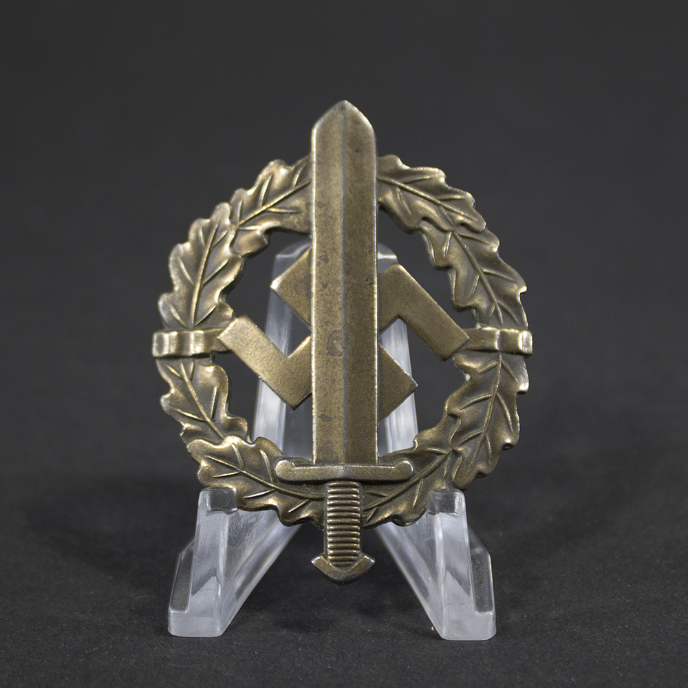 Overview of a World War II German Bronze SA Sports Badge, displayed in full view to show the complete wreath design, central sword motif, and overall condition of the award.