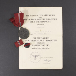 Eastern Front Medal set with original award document, showing the medal, ribbon, and accompanying wartime certificate.