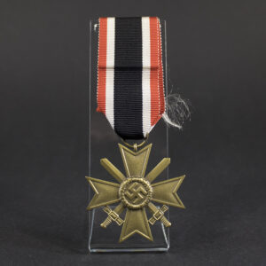 Overall view of a War Merit Cross with Swords, 2nd Class, suspended from its ribbon. The bronze-colored cross features crossed swords between the arms and a central wreath with swastika emblem.