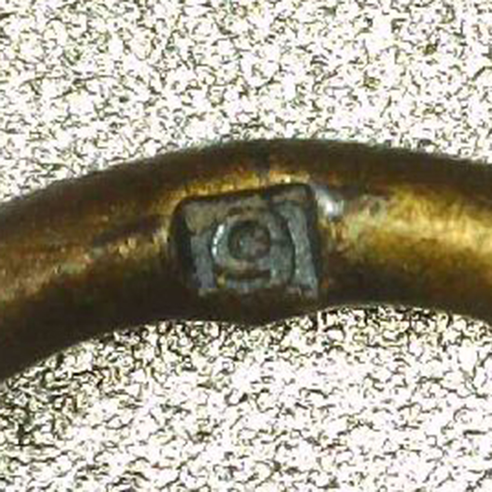 Macro view of the suspension ring of a War Merit Cross with Swords, 2nd Class, showing the maker mark “9” stamped into the ring.