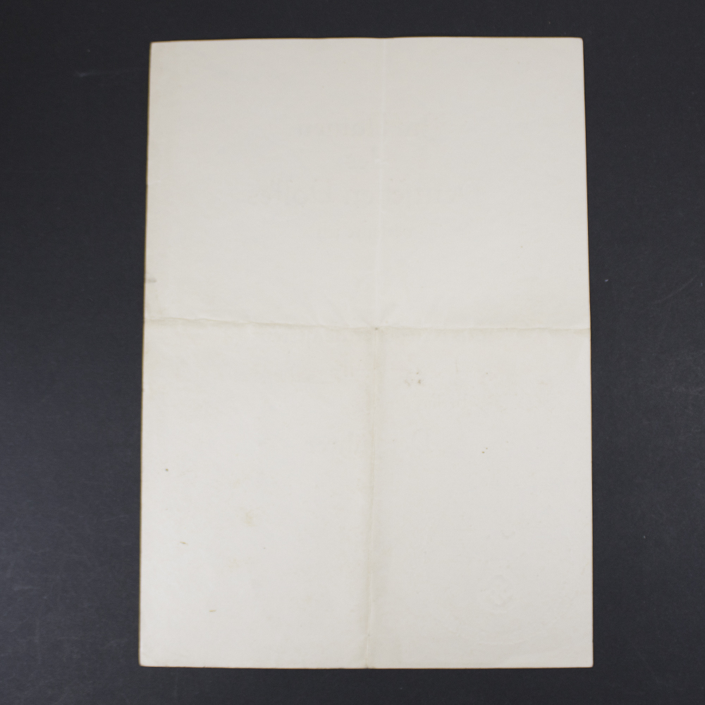 Reverse view of an original War Merit Cross 2nd Class without Swords award document, displaying the blank back side with authentic age-related wear and paper texture.