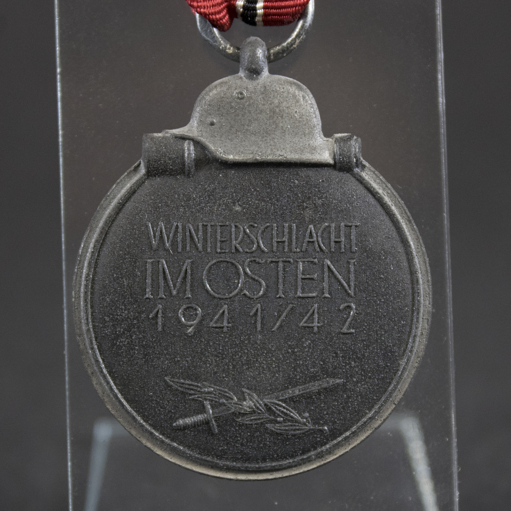 Front view of the original Eastern Front Medal issue bag with printed award designation and period paper construction.